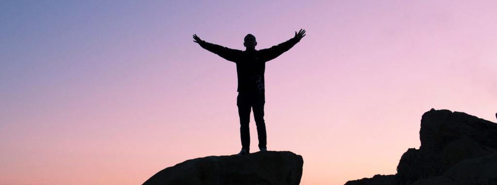 man on top of rock